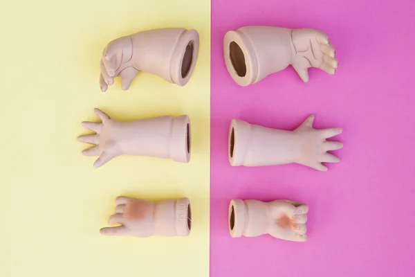 Baby Doll Head, Arms, Face Parts on Yellow and Pink Background