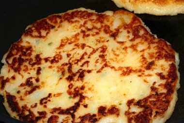 CLose up of fried potato cake fritter toasted brown tasty