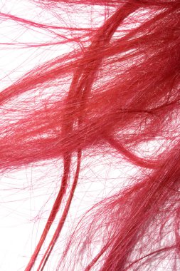 Beyaz arka planda parlak kırmızı saç telleri