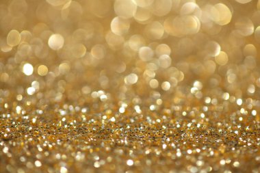 Odaklanma ve bokeh ile altın parıltılı arkaplan