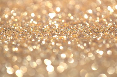 Odaklanma ve bokeh ile altın parıltılı arkaplan