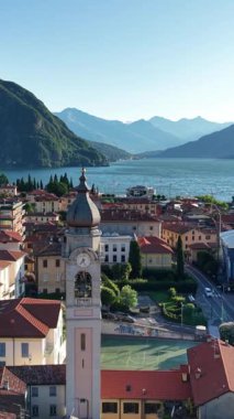 Şafak çanı kulesi sükunet körfezi ve terracotta çatıları, yumuşak pastel gökyüzü, uzak dağlık tepeler,