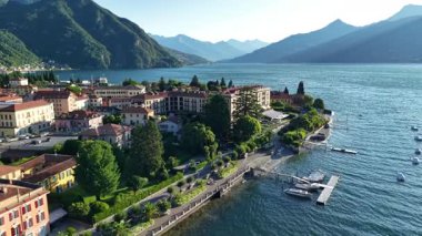 Sabahın erken saatlerinde İtalya 'nın Como Gölü' ndeki Bellagio ve Menaggio kasabalarını gösteriyor. Manzara dağları, su binalarını ve ağaçları içerir. Mimari görünür..