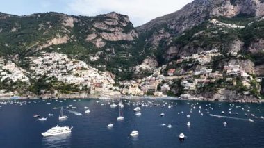 Güzel Positano kayalıklara kurulmuş büyüleyici bir İtalyan sahil kasabası. Birçok tekne güneşli bir günde mavi Tiren Denizi 'ni noktalar..