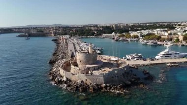 Yüksek açı dalgakıranda Aziz Nicholas Kalesi 'ni gösteriyor. Yunanistan 'ın Rodos Limanı' ndaki Mandraki Limanı açık bir gökyüzü altında yatlarla doldu.