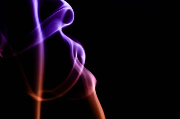 Purple And Orange Smoke Swirls Against Black Background. Abstract Art. Creative Long Exposure Design
