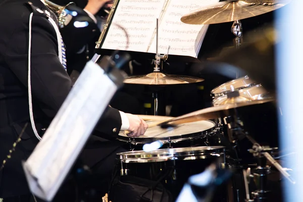 Drummer Playing Drums Percussion In Orchestra Concert Band With Sticks Creating Rhythm And Musical Energy. Shallow Depth Of Focus