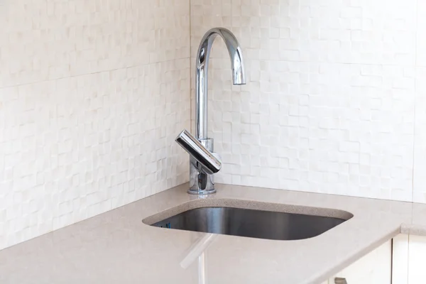 Kitchen stone counter with undermount build-in sink and mixer tap — Stock Photo, Image