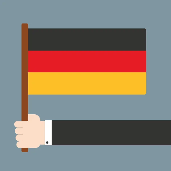 Mano sosteniendo bandera de Alemania — Vector de stock