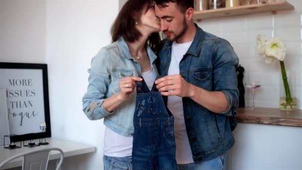 Couple Holding Baby Clothes — Stock Video