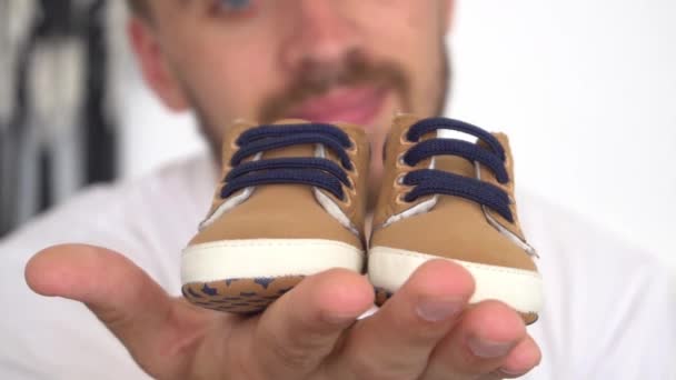 Adult Man Holding Baby Sneakers — Stock Video