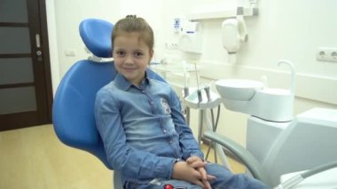 Çok sağlıklı bir gülümsemesi olan güzel bir çocuk, dişçi koltuğunda oturuyor. Benim...
