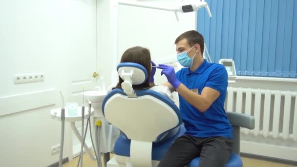 European Young Woman Sitting Medical Chair While Dentist Fixing Her — Stockvideo