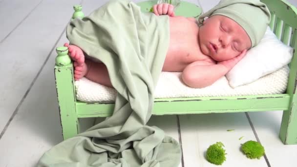 Slow Motion Newborn Baby Hat Covered Green Blanket Sleeping Bed — Stockvideo