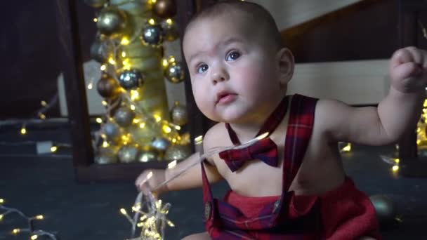 Slow Motion Happy Little Baby Boy Playing Chistmas Lights — Stock Video
