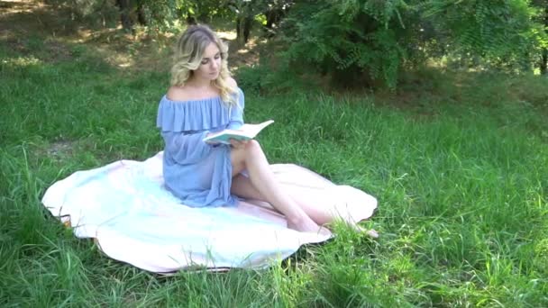 Slow Motion Young Blonde Girl Park Reading Book Grass — Stockvideo