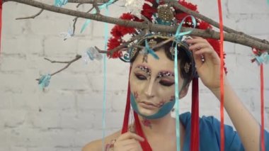 Slow Motion young pretty geisha in blue kimono with sakura