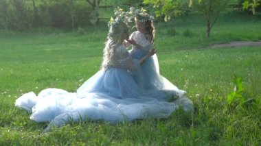 Slow Motion Mum with a little girl outdoors. Happy Mothers Day. Family look. 