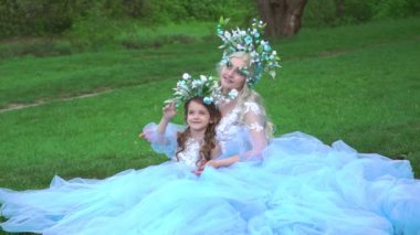 Mother and daughter the queen and princess dresses in a long dress with train 