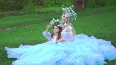 Slow Motion Two beautiful princess girls in luxurious dresses with a long train.