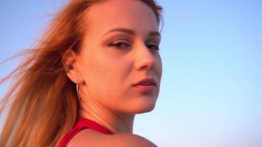 Slow Motion Summer fashion portrait of stunning woman posing on the beach
