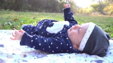 Slow Motion cute little baby in autumn park with yellow leaves