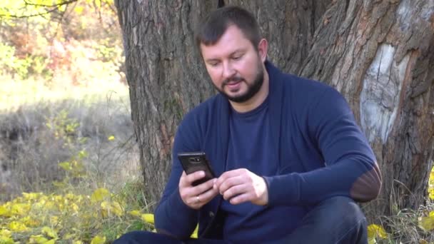 Slow Motion Man Checking Phone Standing Autumn Park Outdoors — Stockvideo