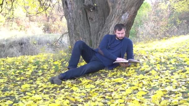 Slow Motion Handsome Unshaven Man Reading Book While Resting Autumn — Wideo stockowe