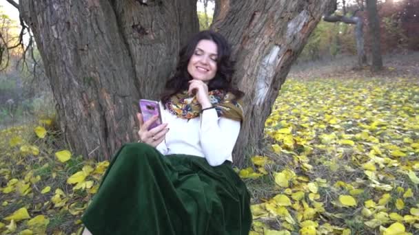 Young Woman Using Mobile Phone Relaxing Park Autumn Sunset — Stock video