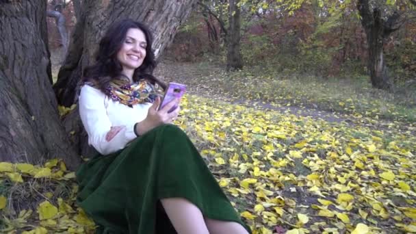 Slow Motion Young Woman Using Mobile Phone Autumn Park — Vídeo de stock