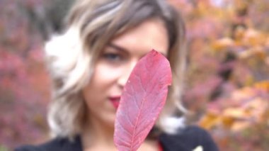 Slow Motion beautiful girl with a yellow maple leaf, autumn portrait, autumn moo
