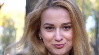Slow Motion Portrait of young blond woman in autumn color