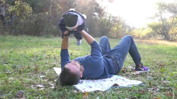 慢动作可爱的小男孩和他的父亲在秋天的公园里 — 图库视频影像