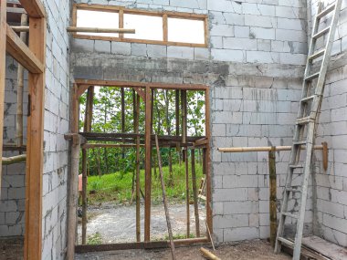 Selective focus. Door jamb installation in concrete wall. Wooden doors.