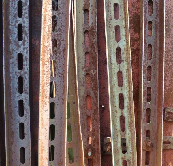 Aged rusty metal corners with perforation. Industrial background