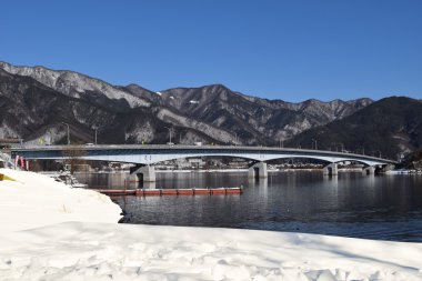 Lake Kawaguchiko Ohashi Bridge during winter with snow (Japan) clipart