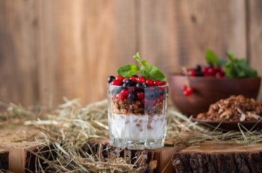 Böğürtlenli granola Kırmızı böğürtlenli granola. Kırsal granola. Tahta ve saman. Ön görünüm.