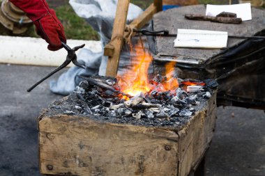 Sıcak demir dövme. Isınma demir dövme. Kızgın demir çekerek için maşa.