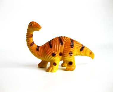 Beyaz arka planda oyuncak dinozorlar.