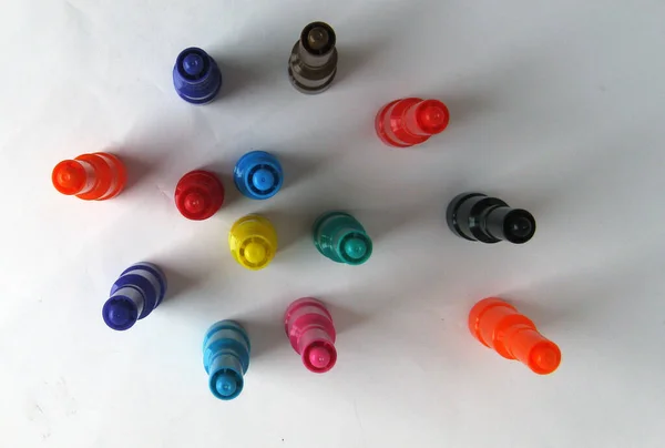 Colored marker caps on white background.