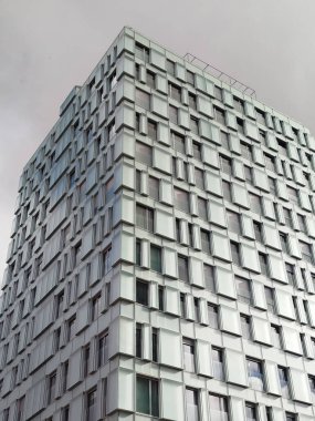 Angular and vertical view of the modern and geometric facade of a skyscraper