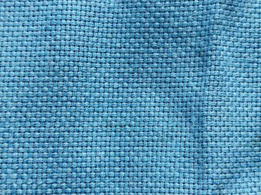 Çuval bezi ya da keten kumaşa benzeyen sert, gökyüzü mavisi bir arka plan.