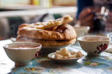 breakfast of coffee with milk and croissant on wooden table