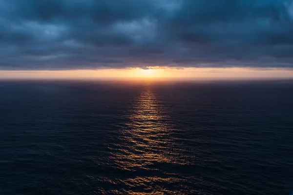 The sunlight pierced the dark blue clouds and lit up the Atlantic Ocean — Stock Photo, Image