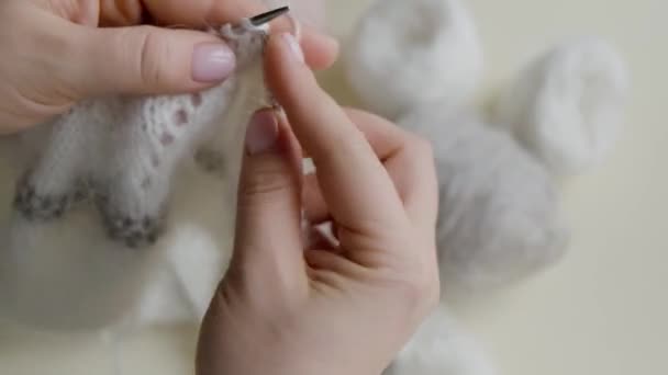 Primo piano delle mani delle donne: un prodotto lavorato a maglia di lana nel colore della vela Champagne con una tonalità grigia e polverosa. — Video Stock