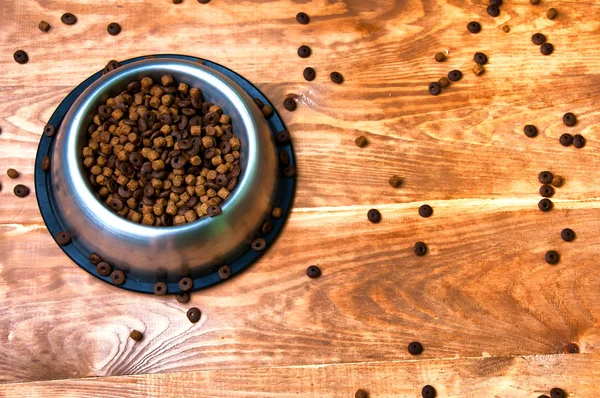 Full dog's bowl on wooden background