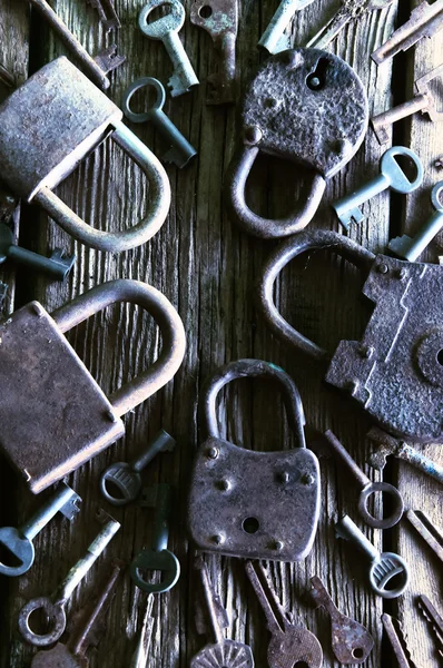 Velho cadeado enferrujado e chaves no fundo de madeira — Fotografia de Stock