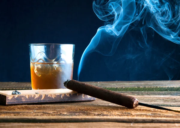 Cigar and whisky with ice on wooden table — Stock Photo, Image