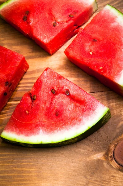 Pieces of watermelon on wooden background — Stock Photo, Image