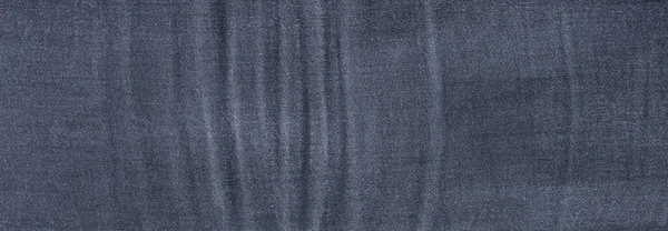 深蓝色牛仔斜纹棉布的质地背景 — 图库照片